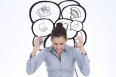 Furious businesswoman gesturing against speech bubbles with app icons
