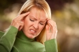 Grimacing Woman Suffering a Painful Headache.