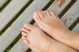 The bare feet of an old woman