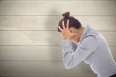 Frustrated businesswoman shouting against bleached wooden planks background