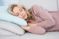 Pretty blonde sleeping on couch at home in the living room