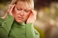 Grimacing Woman Suffering a Painful Headache.