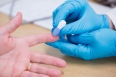 Close up of a doctor testing his patients blood at the hospital