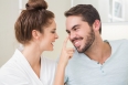 Young woman touching her boyfriends nose at home in the bathroom