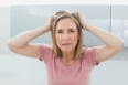 Portrait of a displeased woman pulling her hair