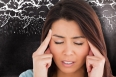 Woman with headache against black background