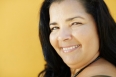 mature hispanic woman smiling at camera