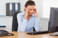 Stressed woman sitting in office