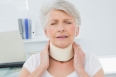 Close-up of a senior woman wearing cervical collar with eyes closed in the medical office