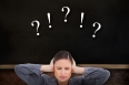 Close up of annoyed tradeswoman covering her ears against chalkboard on brown wallpapered wall