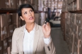 Warehouse manager checking her inventory in a large warehouse